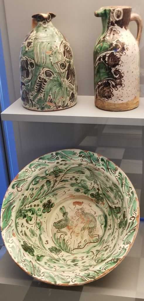 Kitchen ceramics from the Talavera green and purple series, from top left to right, circa 15th century olive oil bottle, circa 15th century jug, bottom, and circa 18th century earthenware bow