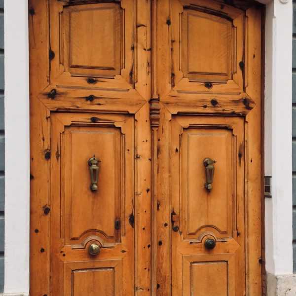 Carved wooden door in Oliva, Valencia, Spain