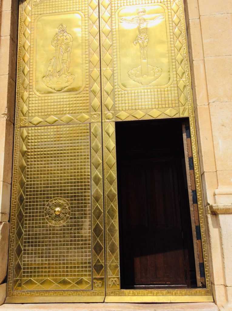 Golden entry door of San Roc Parish Church in Oliva, Valencia, Spain